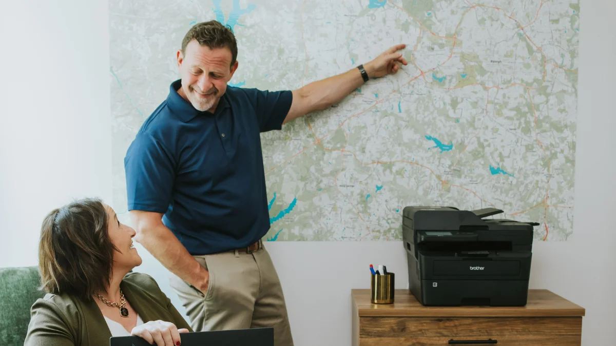 Allan pointing to a map