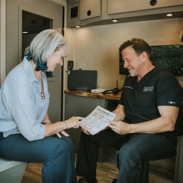Allan doing a hearing evaluation with a patient