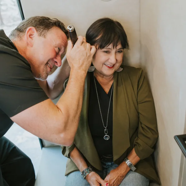 Allan using an otoscope on a patient